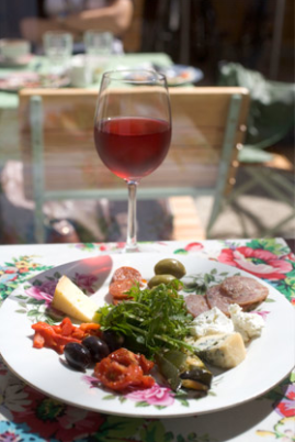 This is a picture of a dish and a glass of wine from Cake Café Restaurant