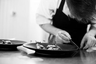 this picture shows you the Ox restaurant Chef cooking